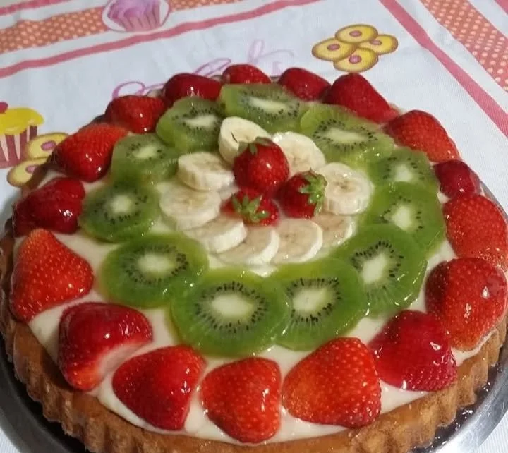 Crostata morbida con crema pasticcera e frutta fresca decorata.