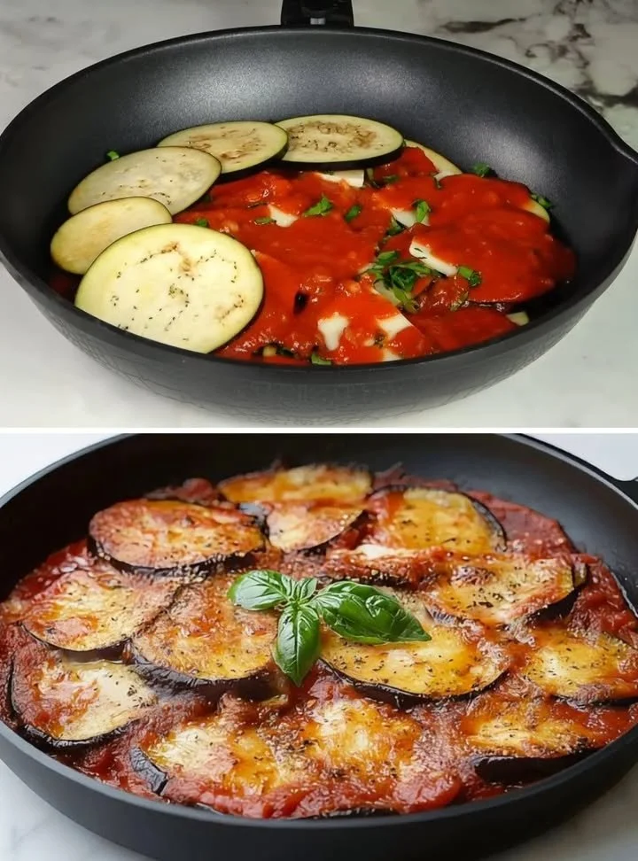 Piatto di Melanzane alla Parmigiana appena sfornato con formaggio fuso e basilico fresco.