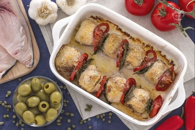Involtini di pesce spada preparati con erbe aromatiche e pomodoro